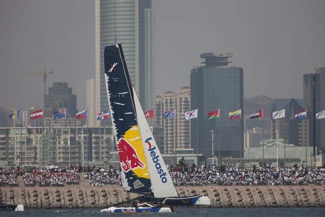 Red Bull Sailing Team flying a hull in front of spectators lining the breakwater in Fushan Bay - Act 2, Day 1, Extreme Sailing Series 2012 &copy; Lloyd Images http://lloydimagesgallery.photoshelter.com/